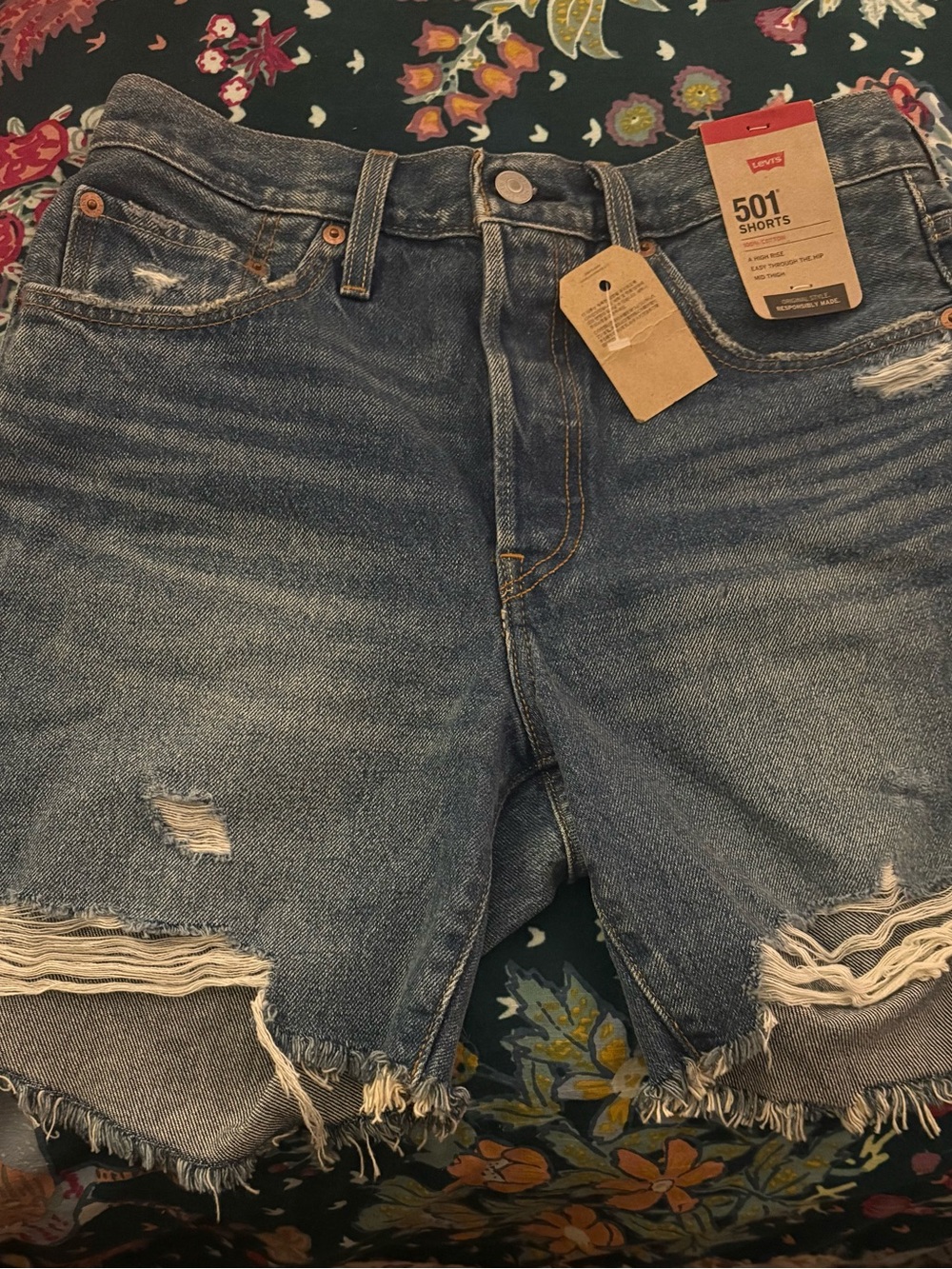 Levi's Distressed Frayed Hem Denim Shorts in Medium Blue